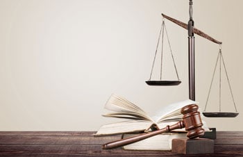 Checks and Balances Scale With Book and Gavel